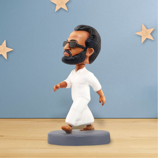 bobblehead figurine wearing sunglasses and white outfit, decorative dashboard and desk showpiece